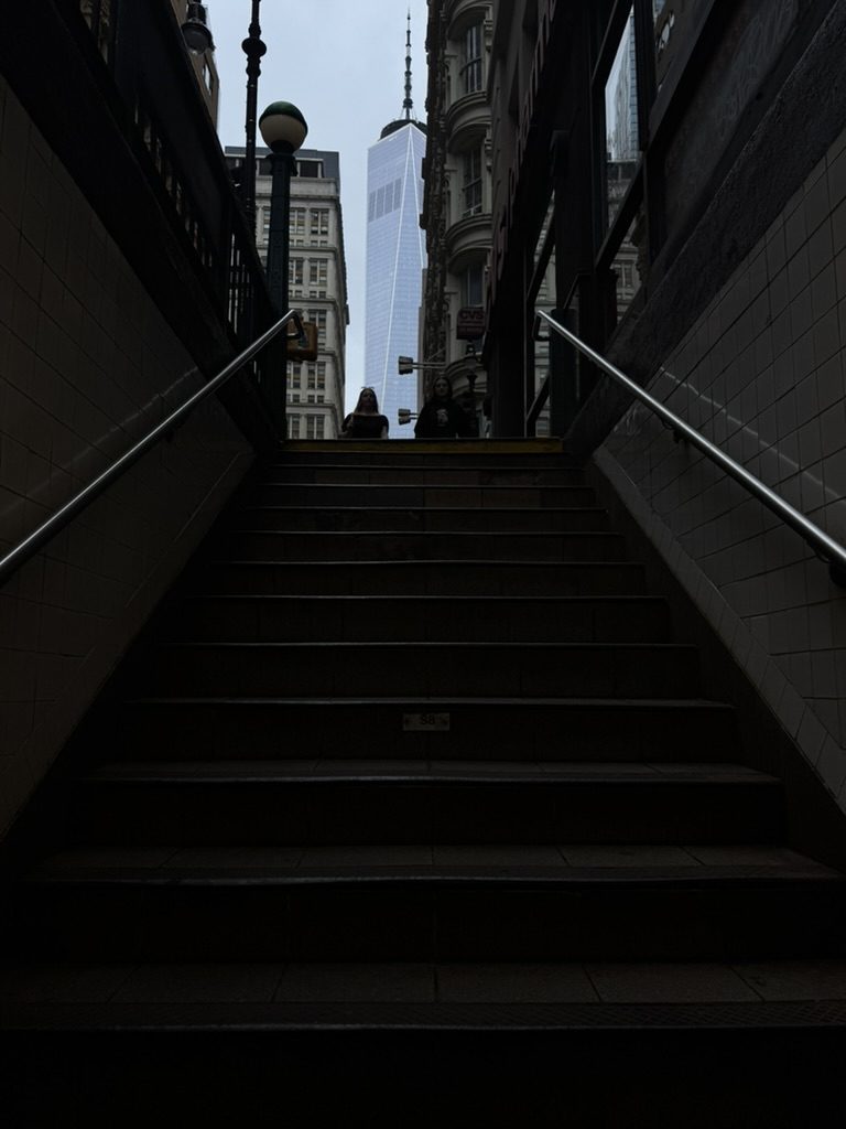 Coming up the subway stairs with One World Trade Center ahead